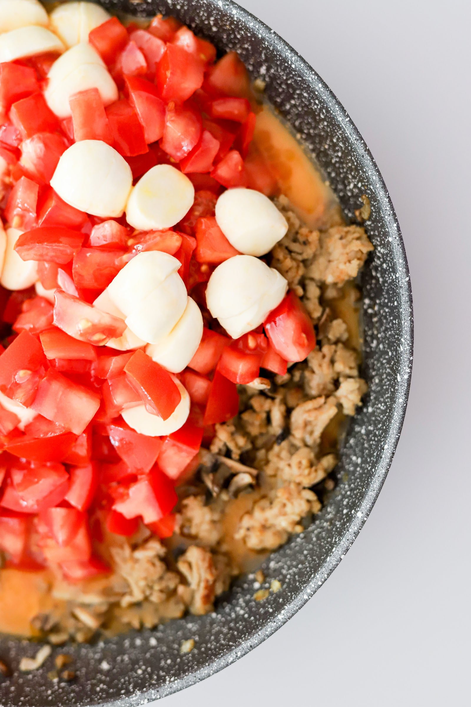 Stuffed baked bell peppers with minced chicken meat, mozzarella and tomatoes